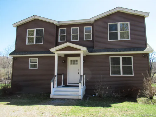 a front view of a house with yard