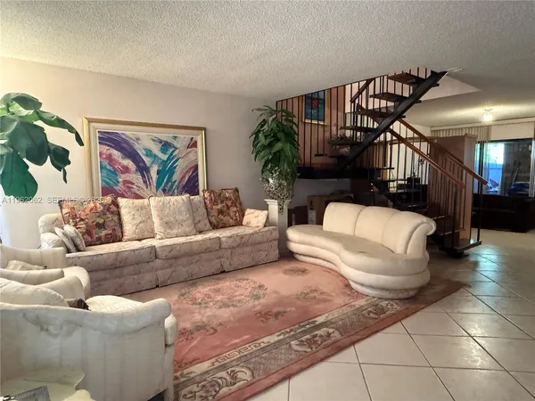 a living room with furniture and a painting