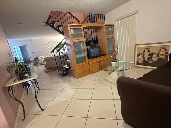 a living room with furniture and a rug