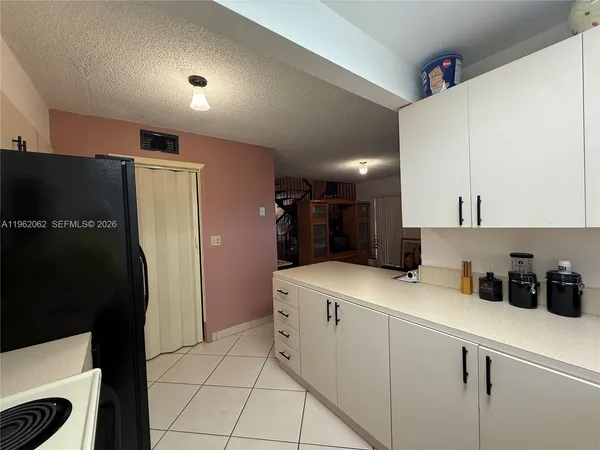 a utility room with cabinets washer and dryer