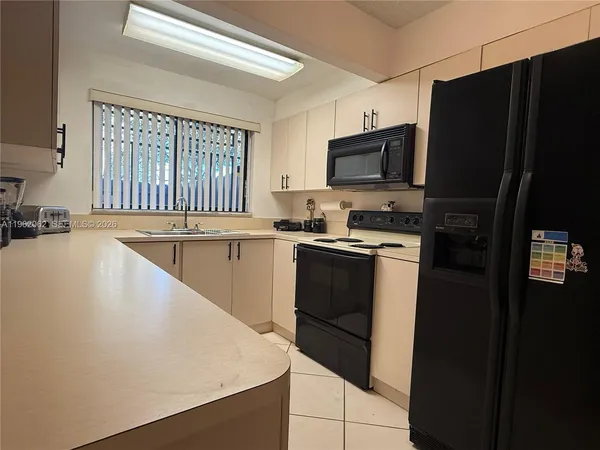 a kitchen with a refrigerator stove and sink