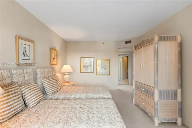 a bedroom with a white bed and a window