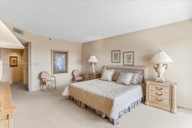 a bedroom with a bed and lamp