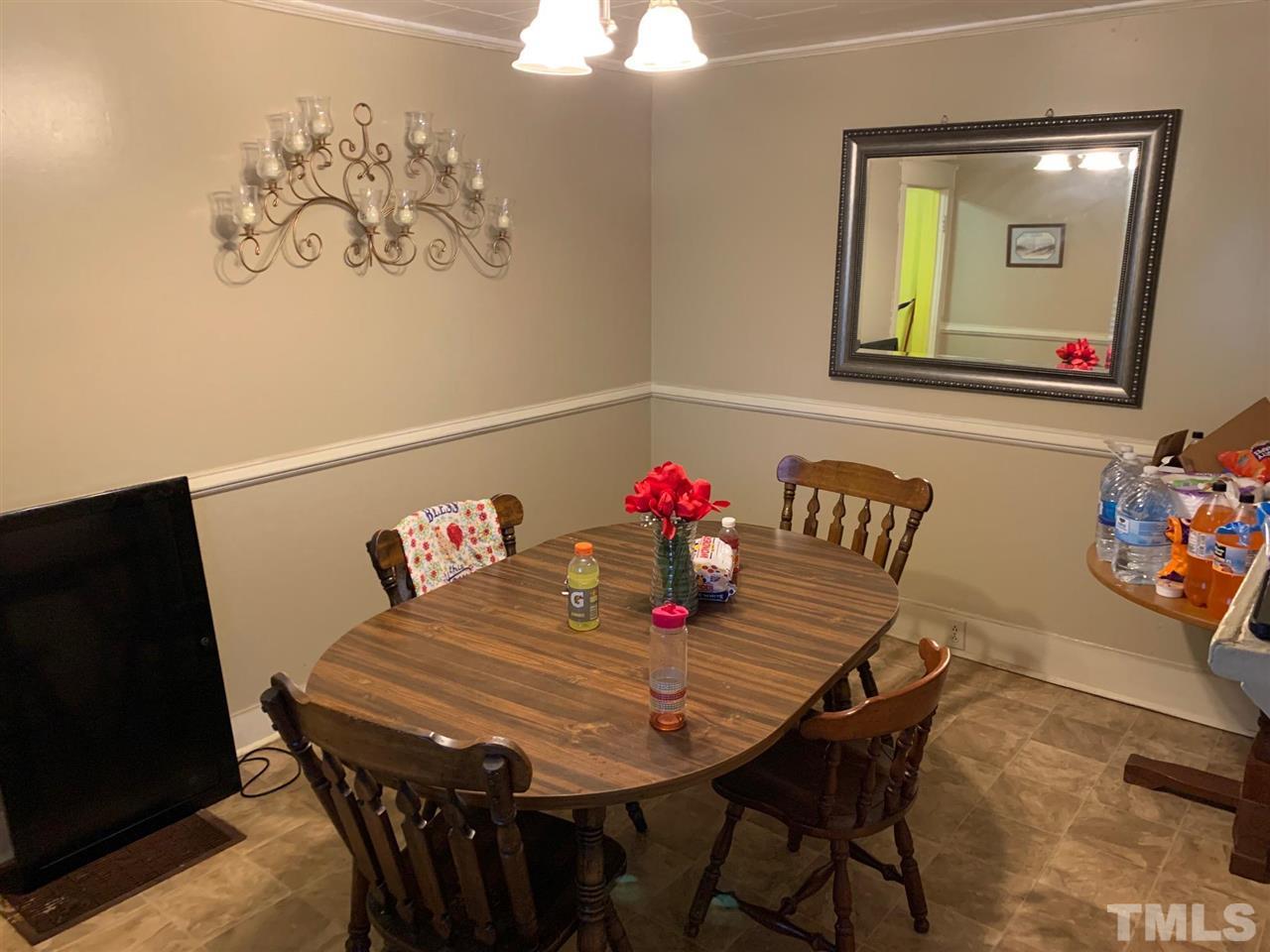 200 Leasburg Road Roxboro, NC 27573 - Photo 4 of 9 a view of a dining room with furniture and wooden floor