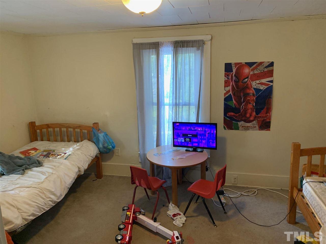 200 Leasburg Road Roxboro, NC 27573 - Photo 6 of 9 a bedroom with a bed a table and chair