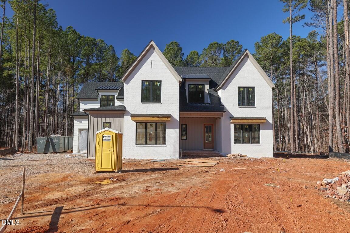 a view of a white house with large trees