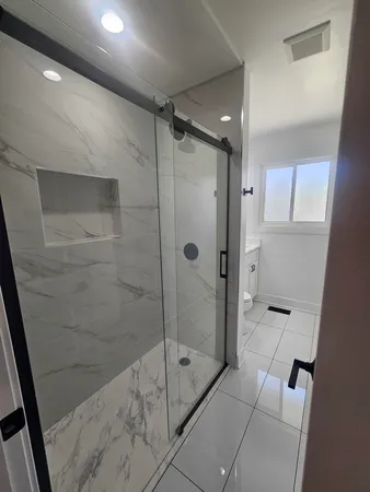 a bathroom with a toilet a sink and a window