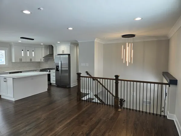 a kitchen with a wooden floor and window