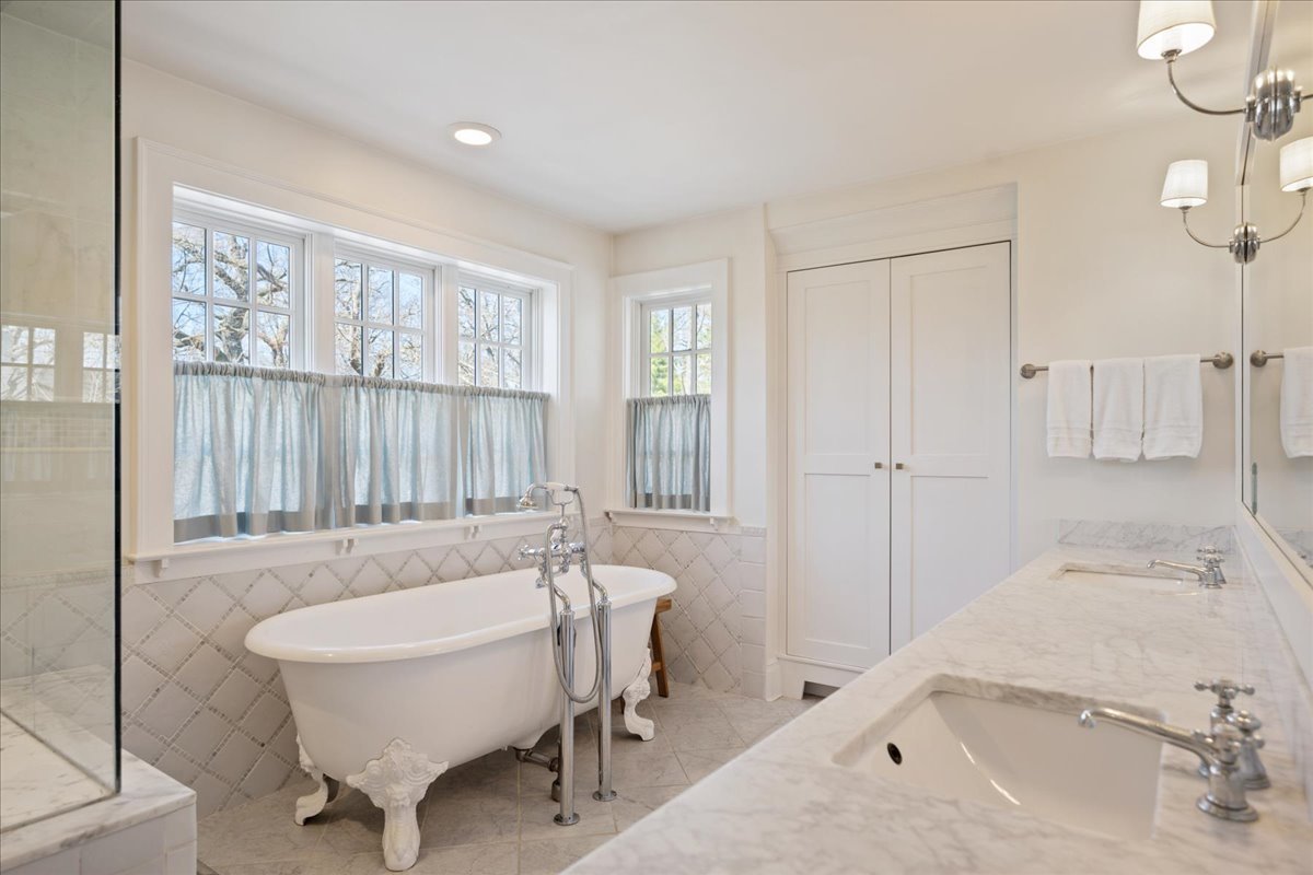 755 Sheridan Road Glencoe, IL 60022 - Photo 23 of 36 a spacious bathroom with a tub sink and mirror
