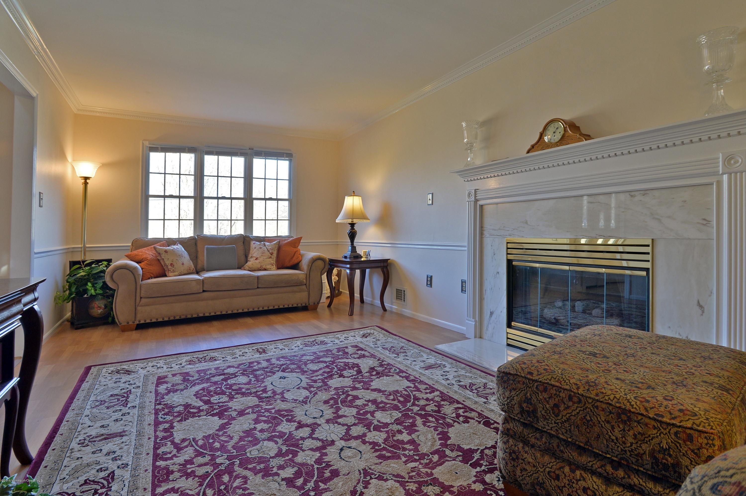 357 Oak Hill Road Middletown, NJ 07701 - Photo 18 of 24 a living room with furniture and a fireplace