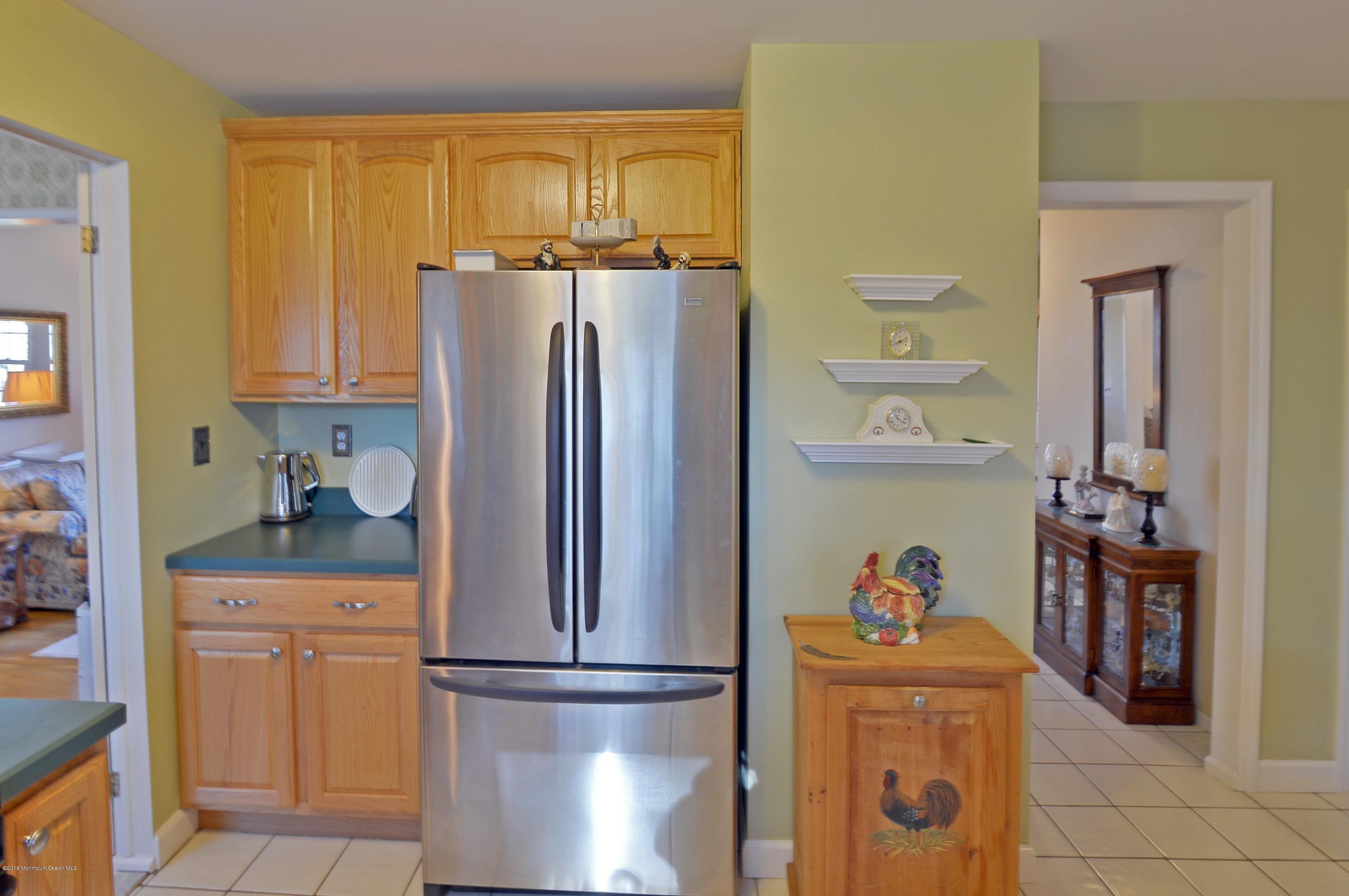 357 Oak Hill Road Middletown, NJ 07701 - Photo 5 of 24 a kitchen with a refrigerator and cabinets