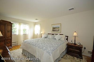 357 Oak Hill Road Middletown, NJ 07701 - Photo 8 of 24 a bedroom with a bed and wooden floor