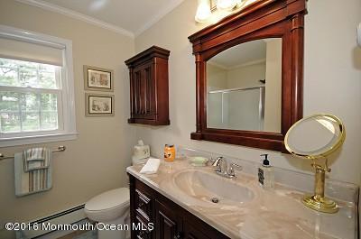 357 Oak Hill Road Middletown, NJ 07701 - Photo 9 of 24 a bathroom with a toilet sink and mirror