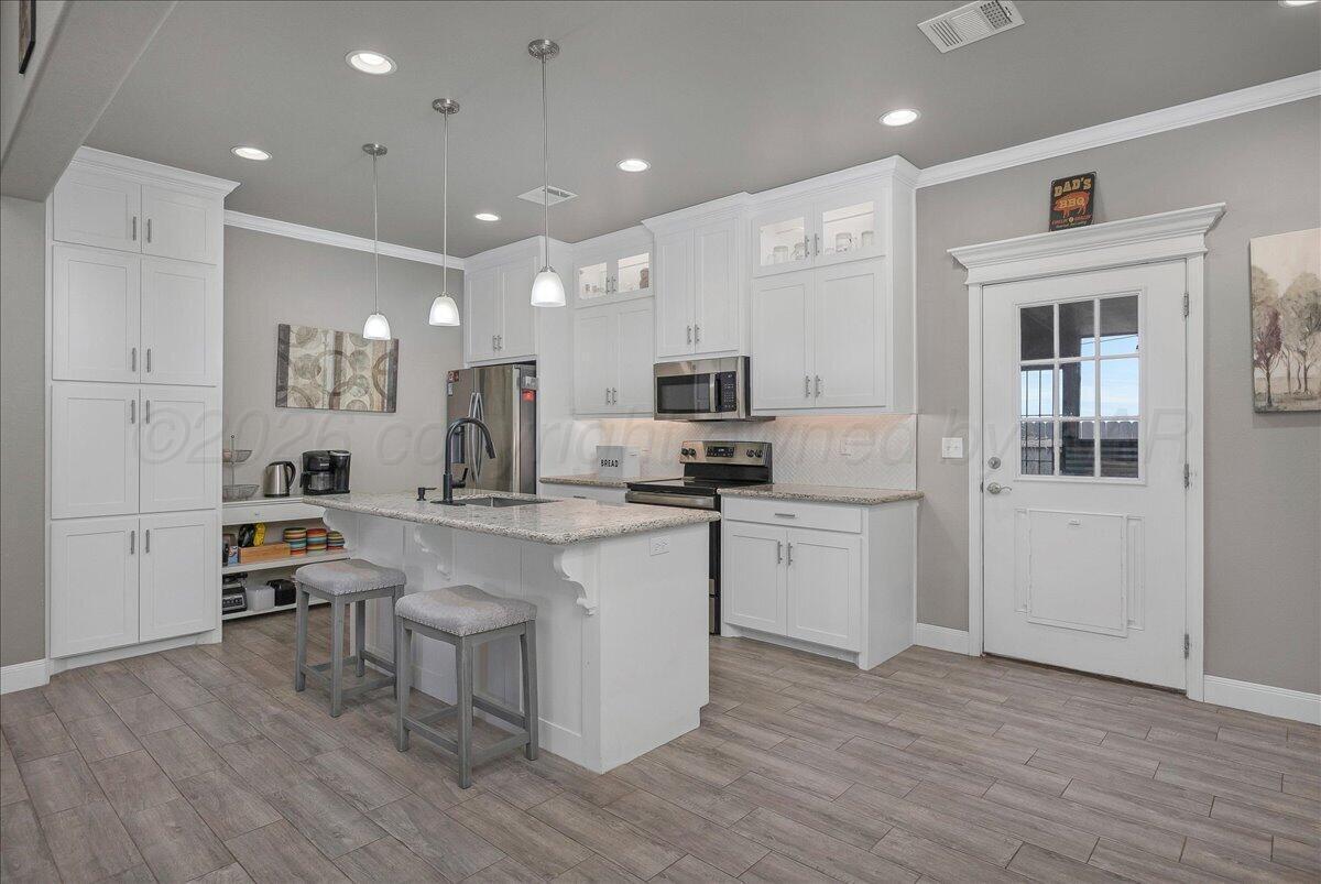 39 Cm Lane Canyon, TX 79015 - Photo 6 of 26 a kitchen with a sink cabinets and wooden floor