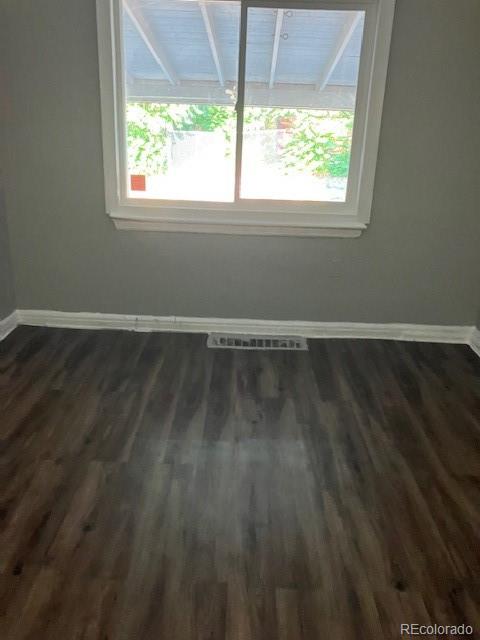 4775 Decatur Street Denver, CO 80211 - Photo 6 of 13 a view of an empty room with wooden floor and a window
