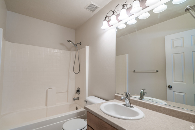 1735 West 540 North, Unit 1805 St. George, UT 84770 - Photo 50 of 64 Bathroom featuring a single vanity with an integrated sink, broad wall mirror, and a full bathtub with an overhead shower