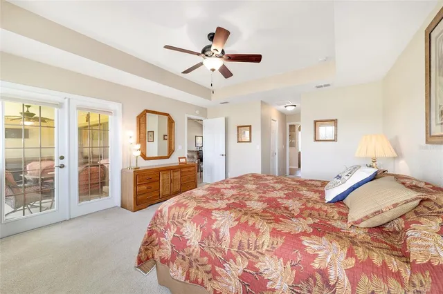 a bedroom with a large bed and a chandelier