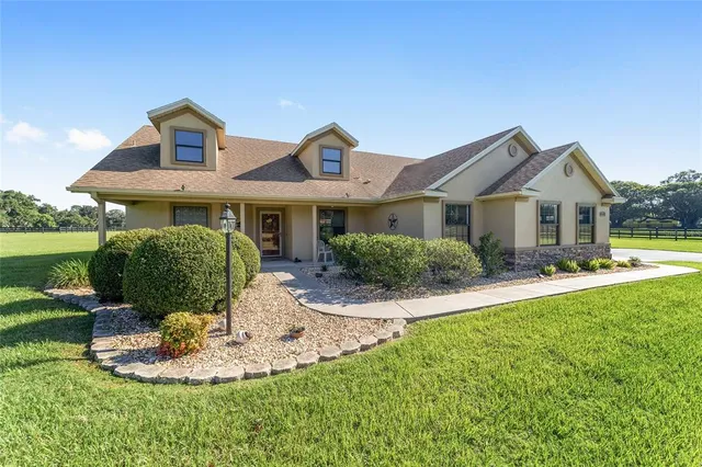 a front view of a house with a yard table and chairs