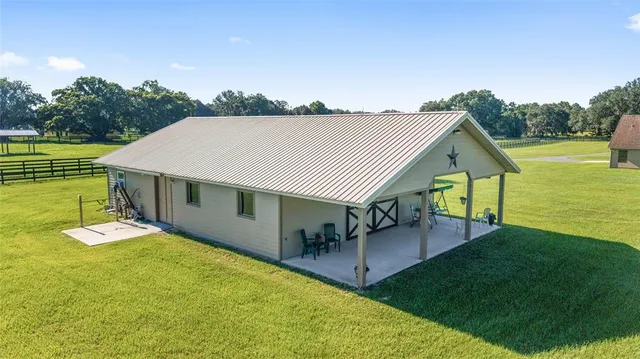 a view of a house with pool and a yard