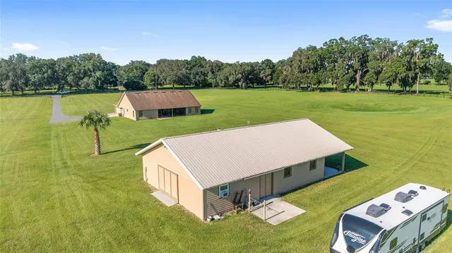 an aerial view of a house with pool garden