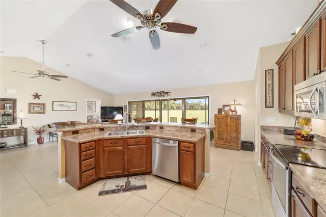 a kitchen with a stove a sink a refrigerator and a stove