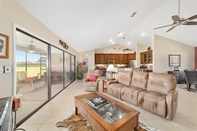 a living room with furniture a large window and glass door