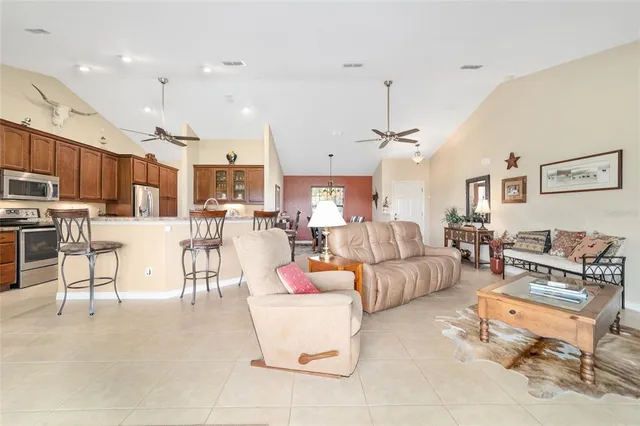 a living room with furniture kitchen view and a kitchen