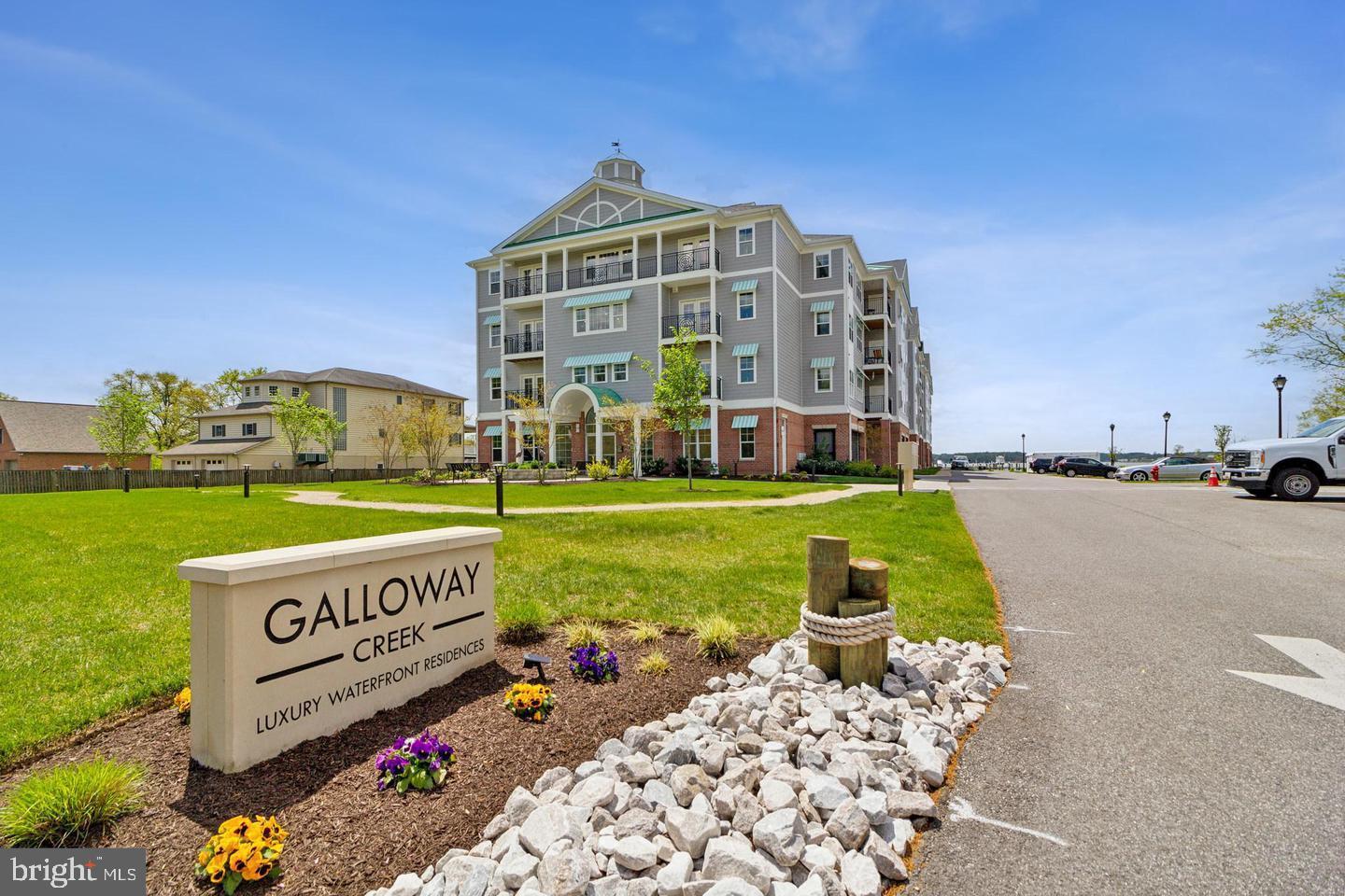 a view of a building with a garden and bench