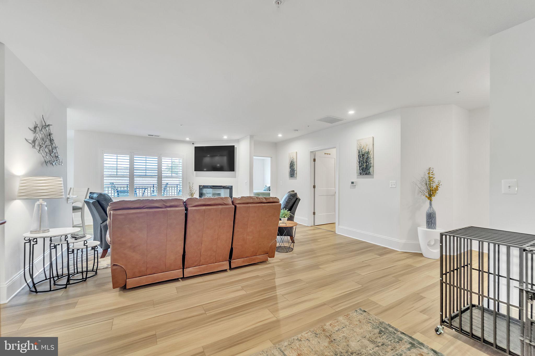 1414 Burke Road, Unit 201 Middle River, MD 21220 - Photo 12 of 35 a living room with furniture a wooden floor and a flat screen tv
