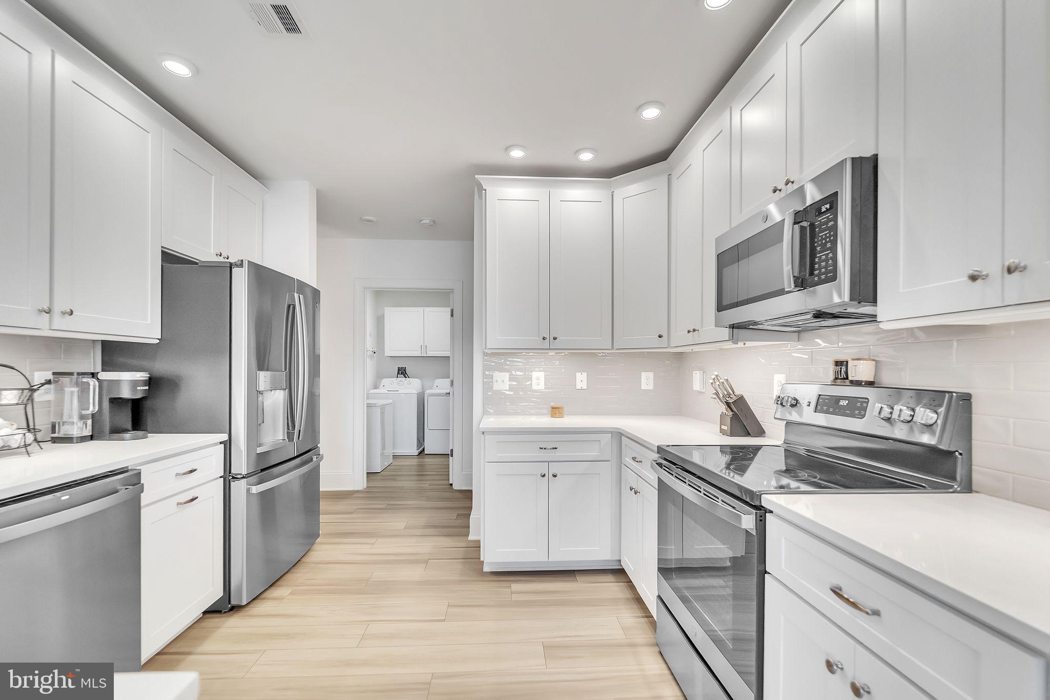 1414 Burke Road, Unit 201 Middle River, MD 21220 - Photo 14 of 35 a kitchen with stainless steel appliances granite countertop a refrigerator sink and cabinets