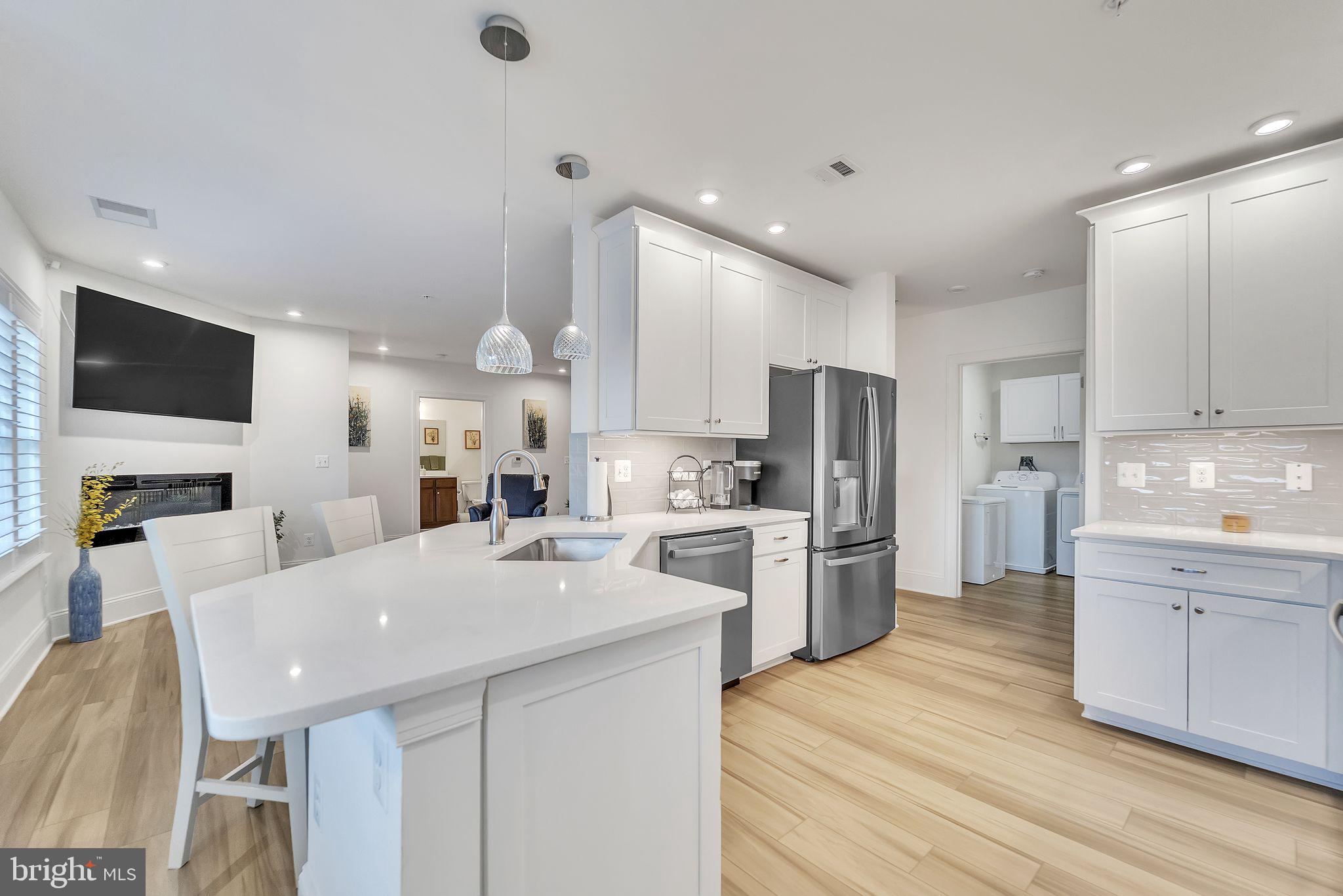 1414 Burke Road, Unit 201 Middle River, MD 21220 - Photo 17 of 35 a large kitchen with kitchen island white cabinets and stainless steel appliances