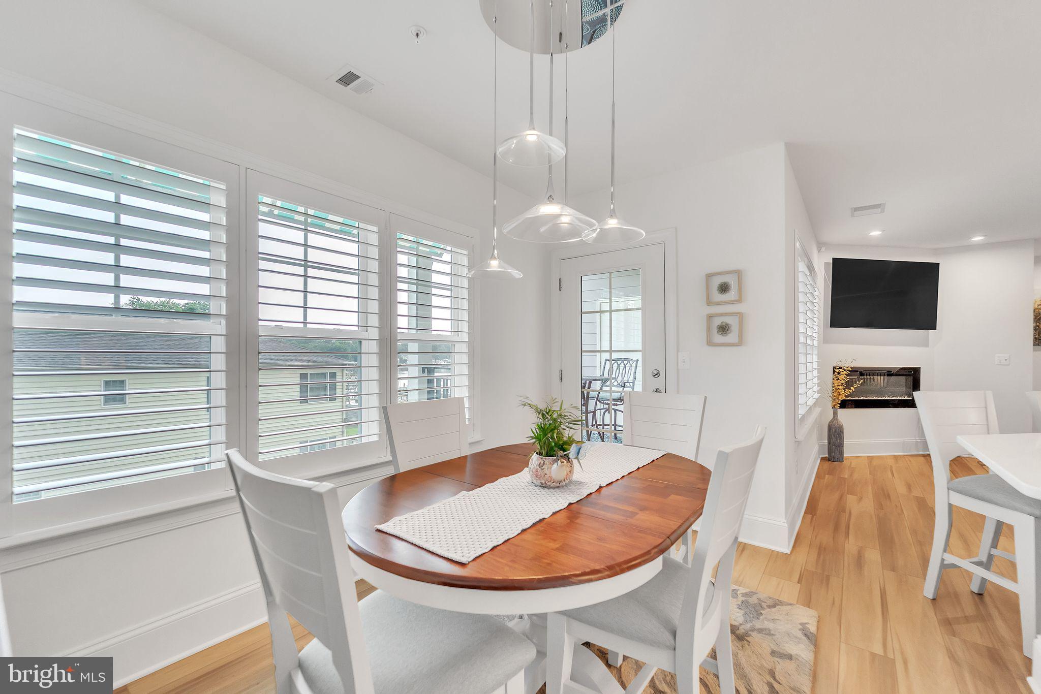1414 Burke Road, Unit 201 Middle River, MD 21220 - Photo 19 of 35 a dining room with furniture a chandelier and wooden floor