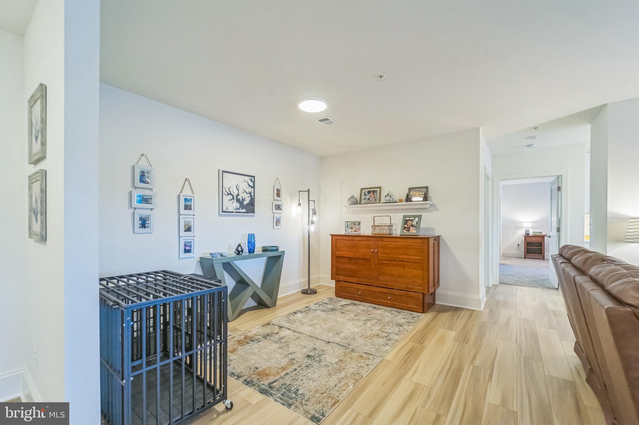 1414 Burke Road, Unit 201 Middle River, MD 21220 - Photo 22 of 35 a bedroom with furniture and wooden floor