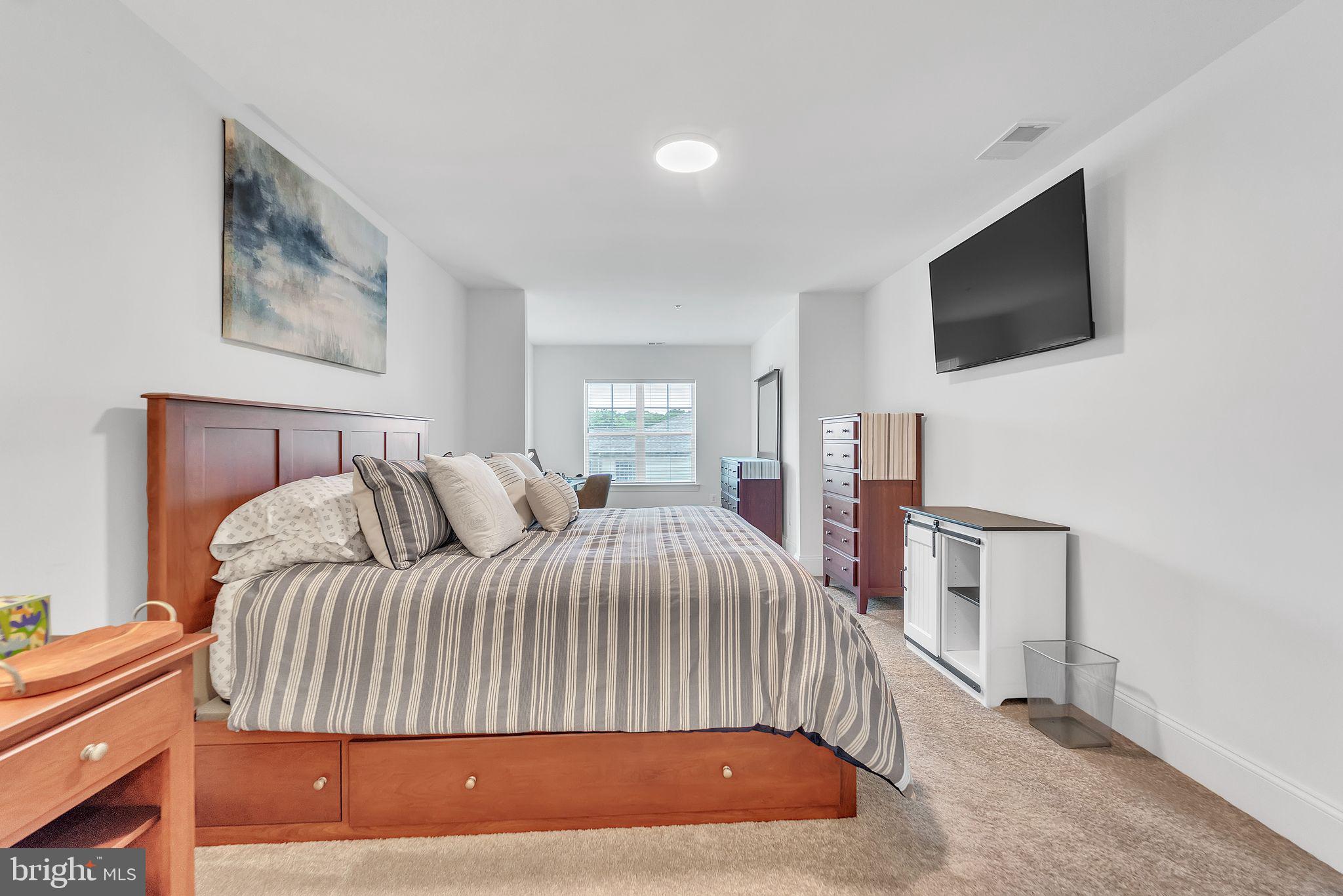 1414 Burke Road, Unit 201 Middle River, MD 21220 - Photo 25 of 35 a bedroom with a bed and a flat screen tv