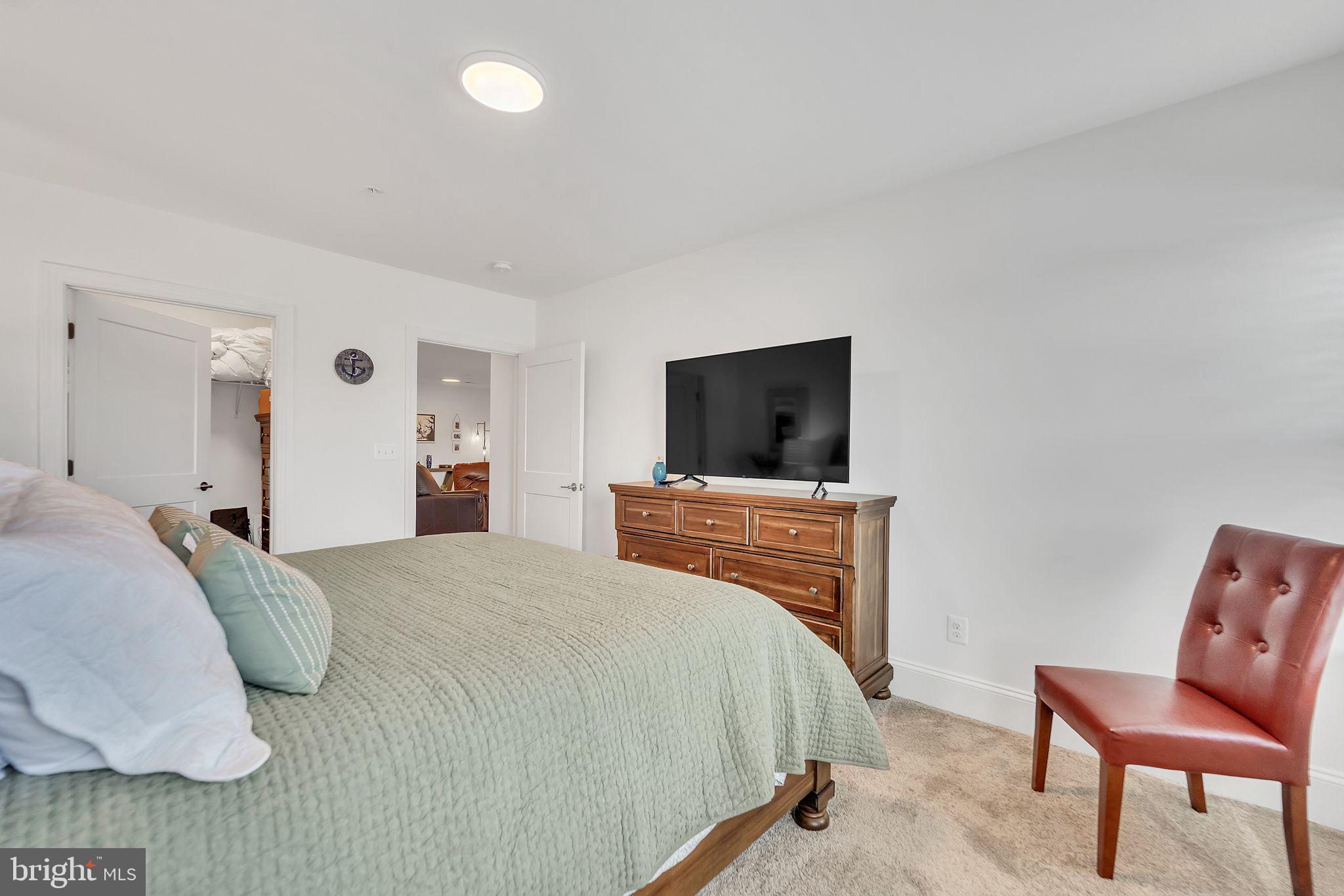 1414 Burke Road, Unit 201 Middle River, MD 21220 - Photo 28 of 35 a bedroom with a bed and a chair