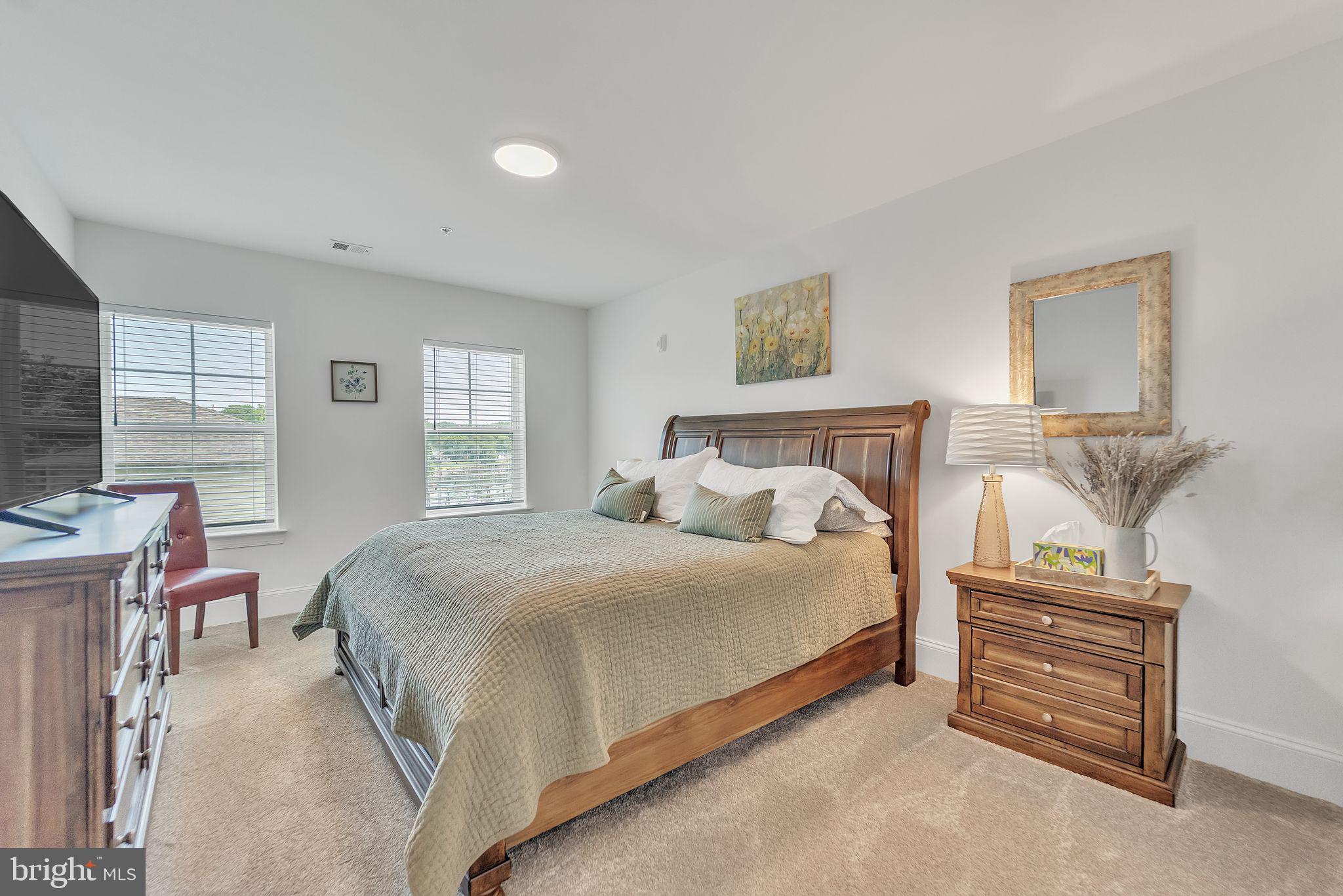 1414 Burke Road, Unit 201 Middle River, MD 21220 - Photo 30 of 35 a bedroom with a bed and a dresser next to a window