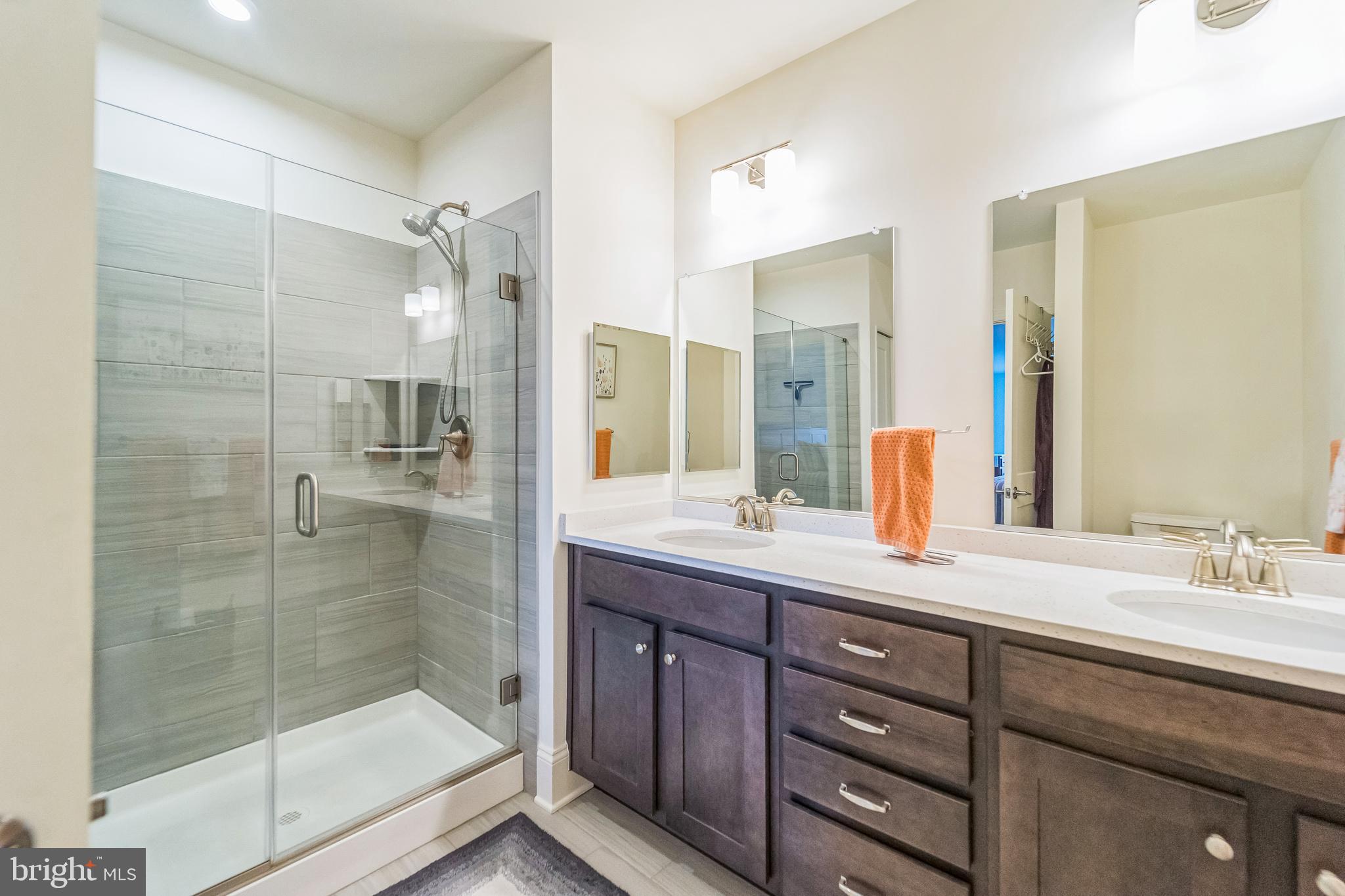1414 Burke Road, Unit 201 Middle River, MD 21220 - Photo 31 of 35 a bathroom with a shower sink and mirror