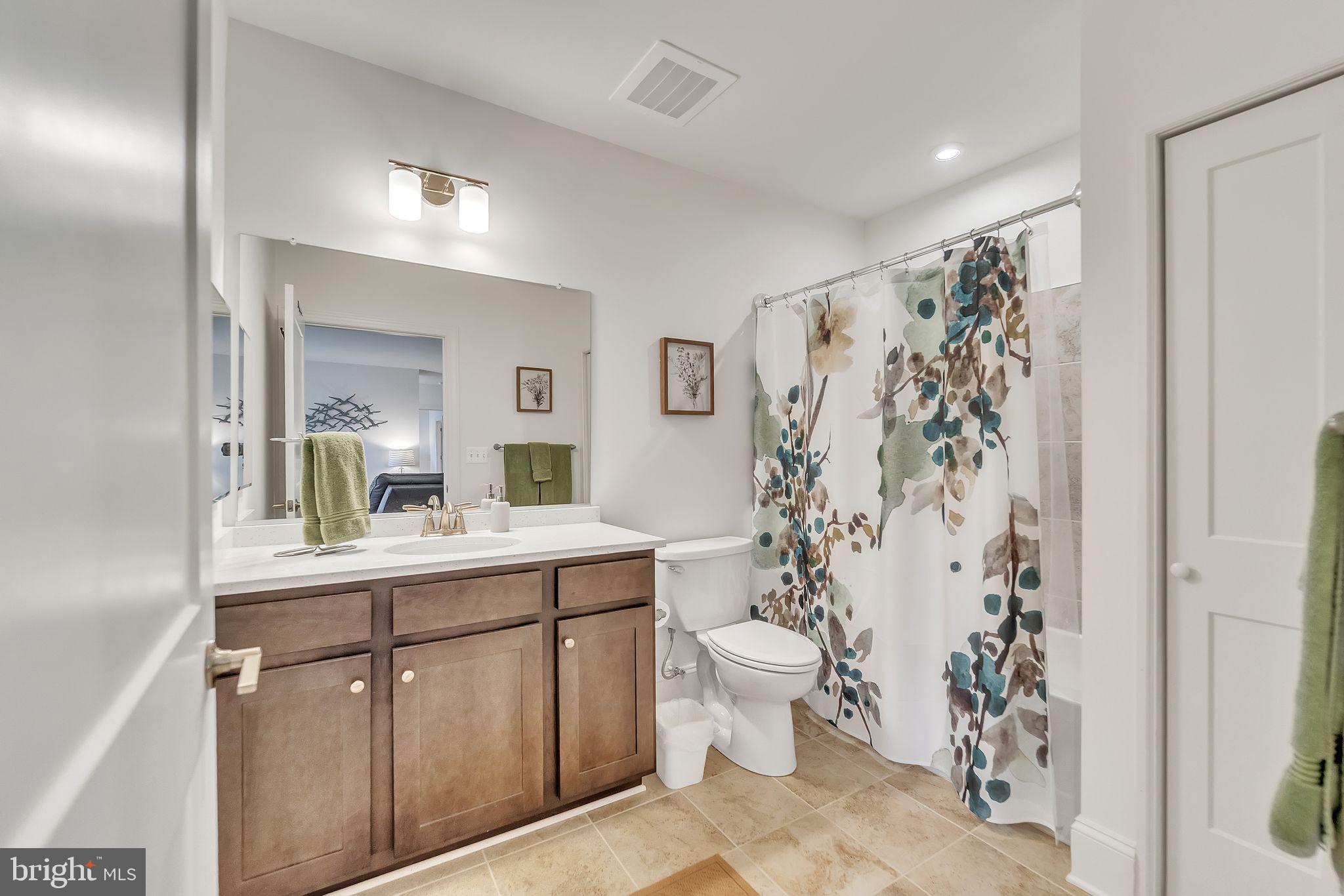 1414 Burke Road, Unit 201 Middle River, MD 21220 - Photo 32 of 35 a view of bathroom with a toilet sink and mirror