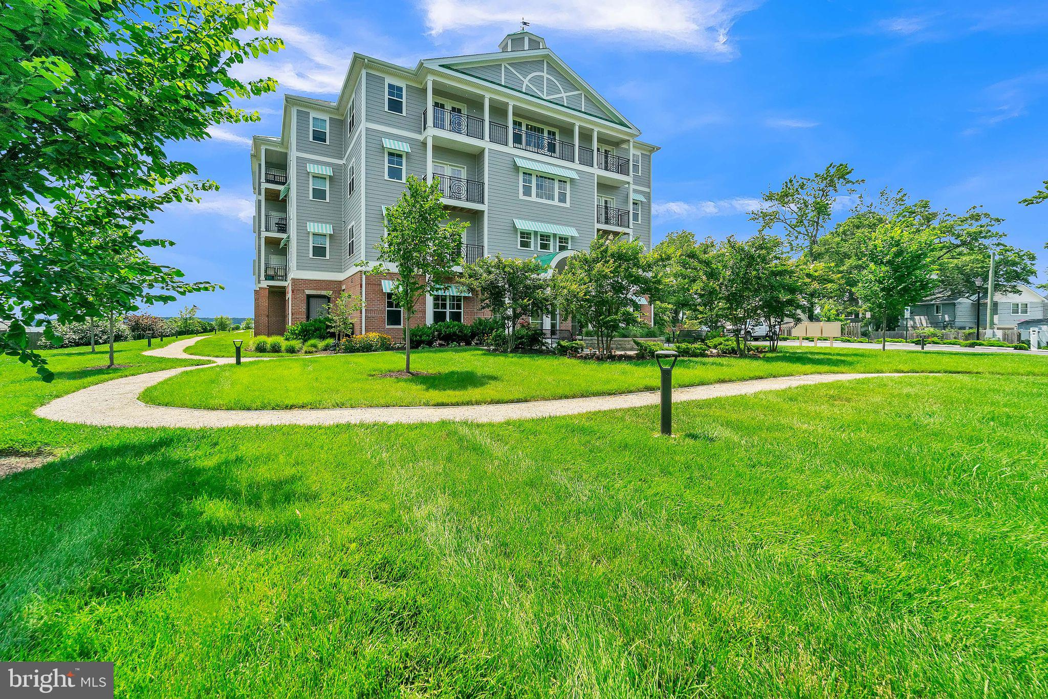 1414 Burke Road, Unit 201 Middle River, MD 21220 - Photo 5 of 35 a view of a big building with a big yard and plants