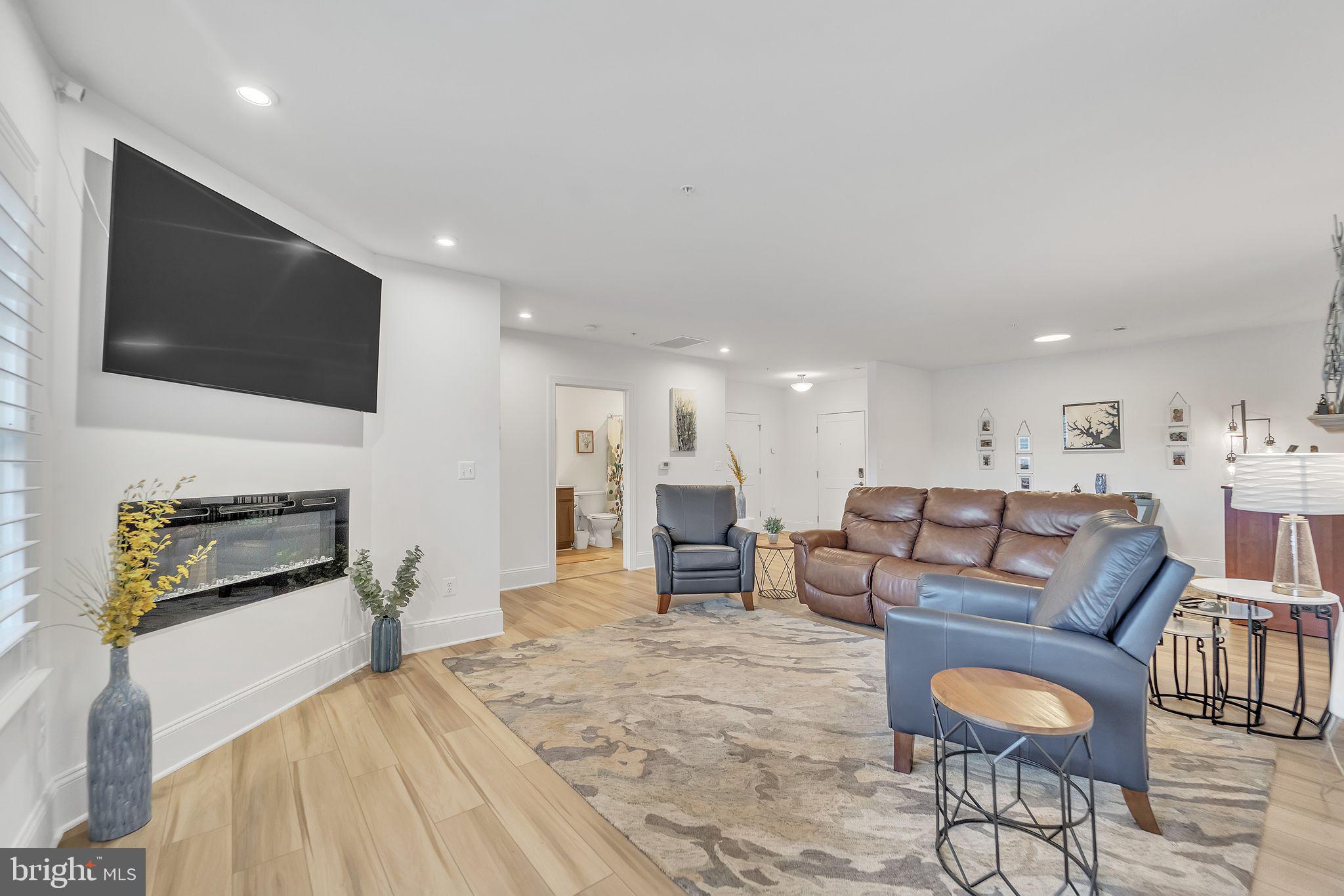 1414 Burke Road, Unit 201 Middle River, MD 21220 - Photo 8 of 35 a living room with furniture and a flat screen tv