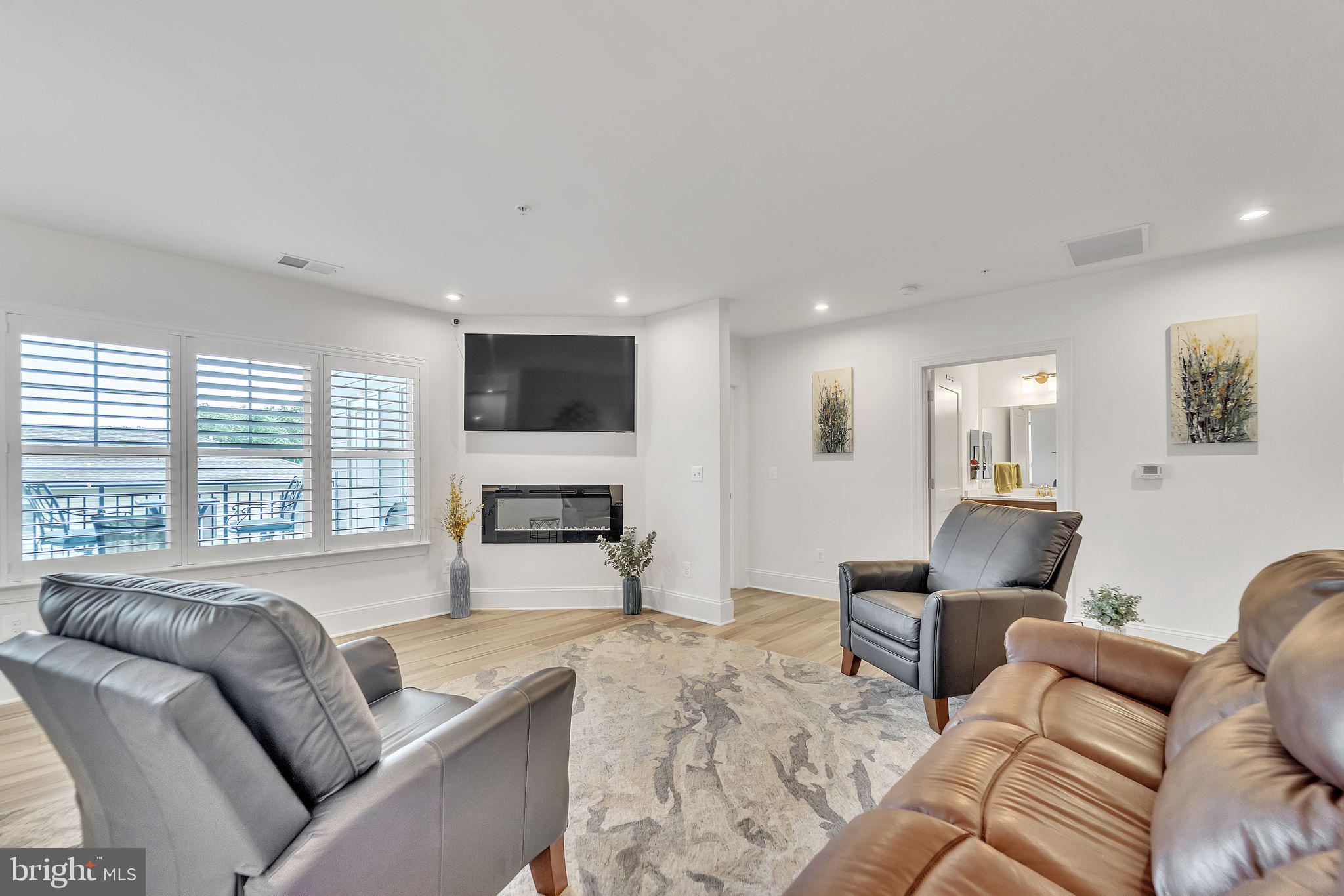 1414 Burke Road, Unit 201 Middle River, MD 21220 - Photo 10 of 35 a living room with furniture and a fireplace