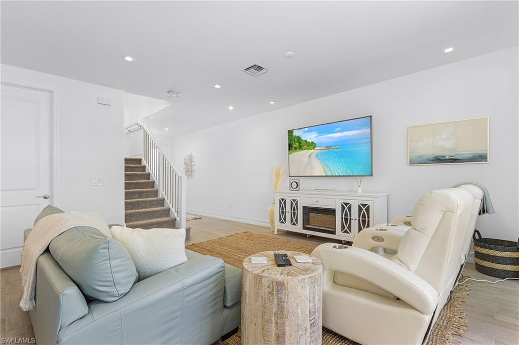 7596 Morgan Way Naples, FL 34119 - Photo 8 of 35 a living room with furniture and a wooden floor