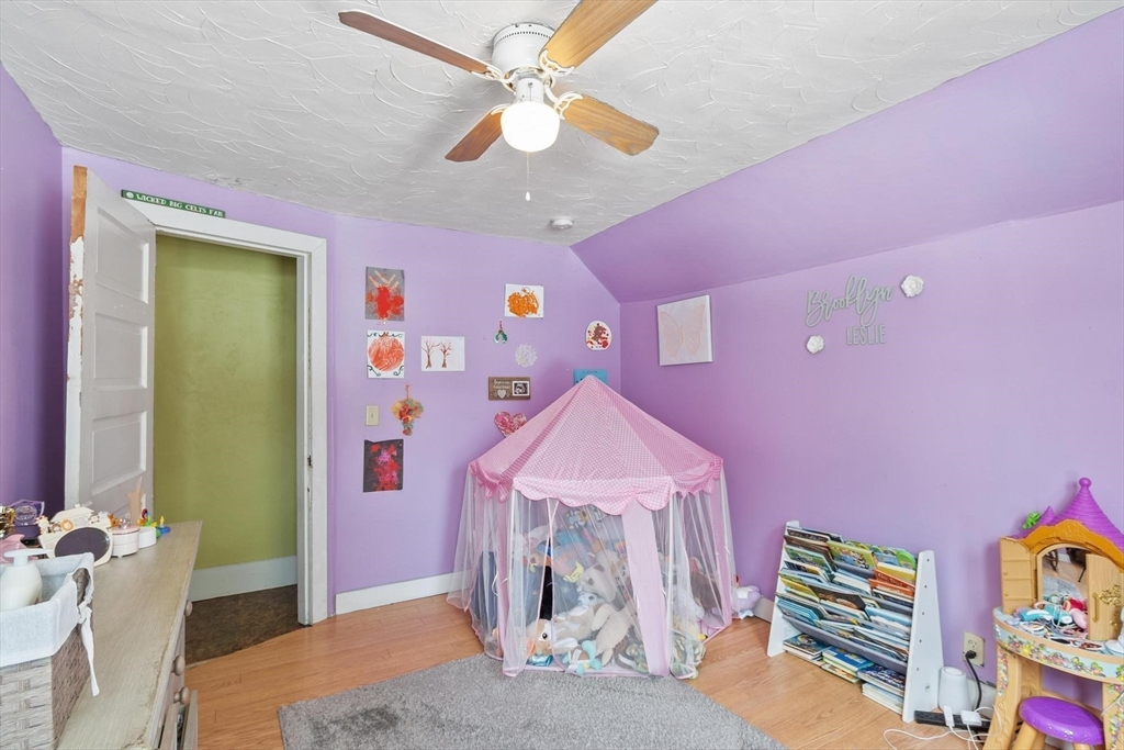37 Draper Road Gardner, MA 01440 - Photo 24 of 33 a bedroom with furniture and a chandelier