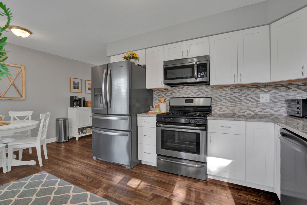 780 Spring Road Elmhurst, IL 60126 - Photo 22 of 42 a kitchen with stainless steel appliances granite countertop a stove a microwave and a refrigerator