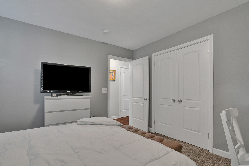 780 Spring Road Elmhurst, IL 60126 - Photo 29 of 42 a bedroom with a bed and a flat screen tv