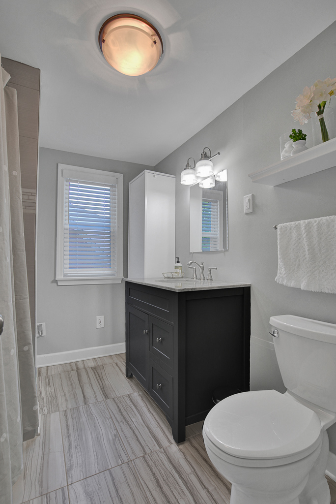 780 Spring Road Elmhurst, IL 60126 - Photo 33 of 42 a bathroom with a toilet sink vanity granite and mirror