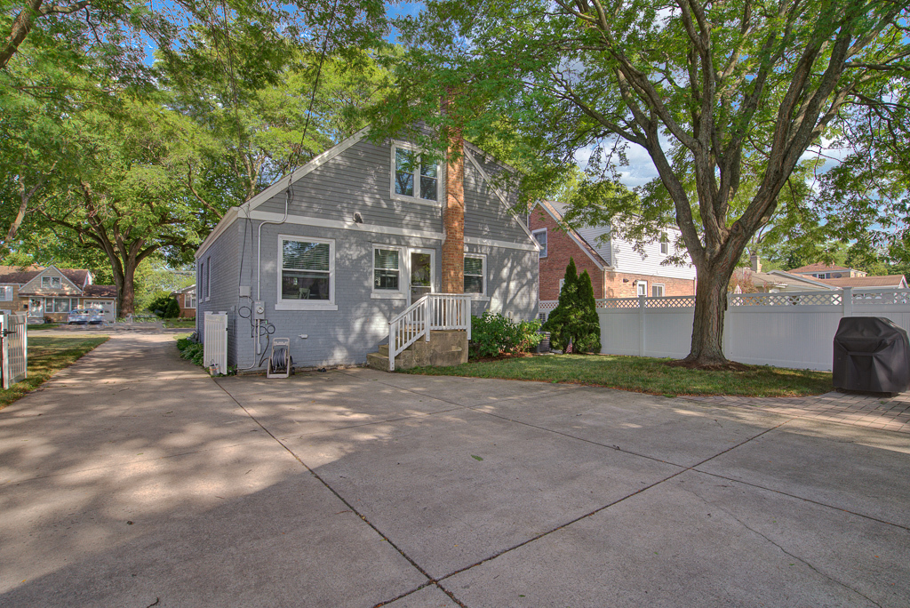780 Spring Road Elmhurst, IL 60126 - Photo 6 of 42 a front view of a house with a yard and garage