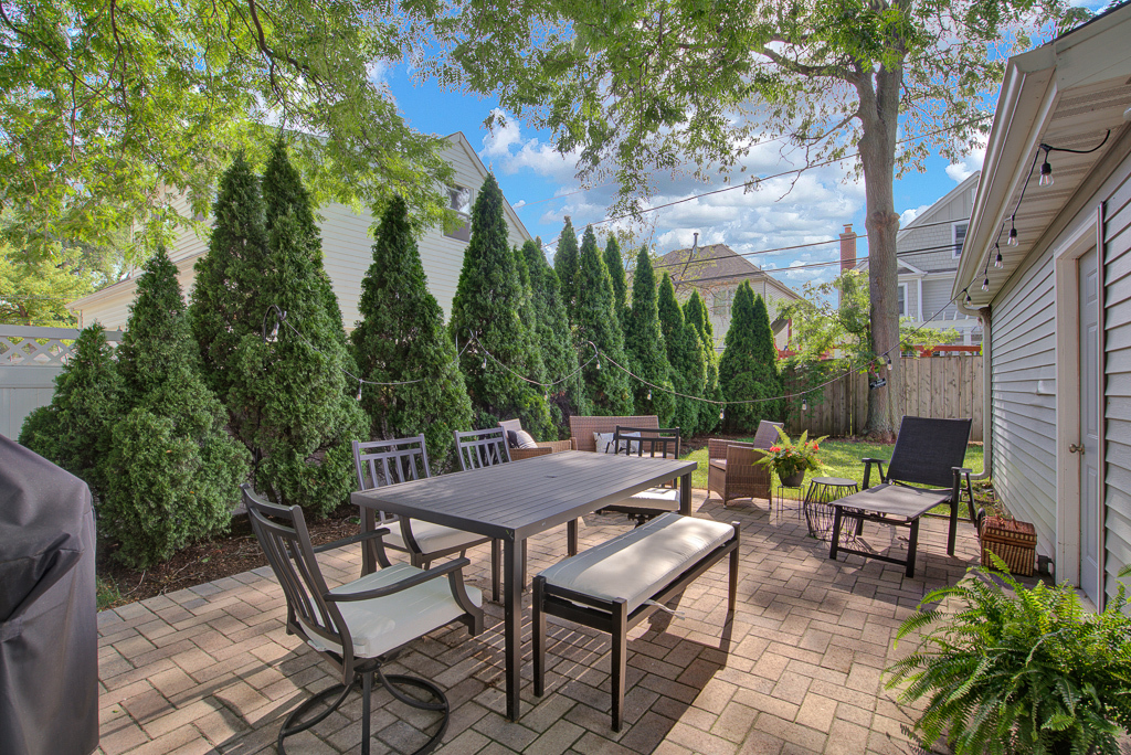 780 Spring Road Elmhurst, IL 60126 - Photo 8 of 42 a view of a patio with table and chairs and potted plants with large tree