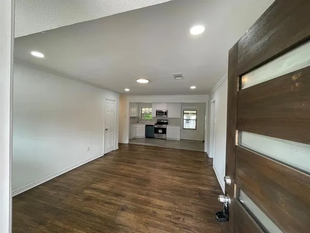 a view of a livingroom with a furniture wooden floor and window