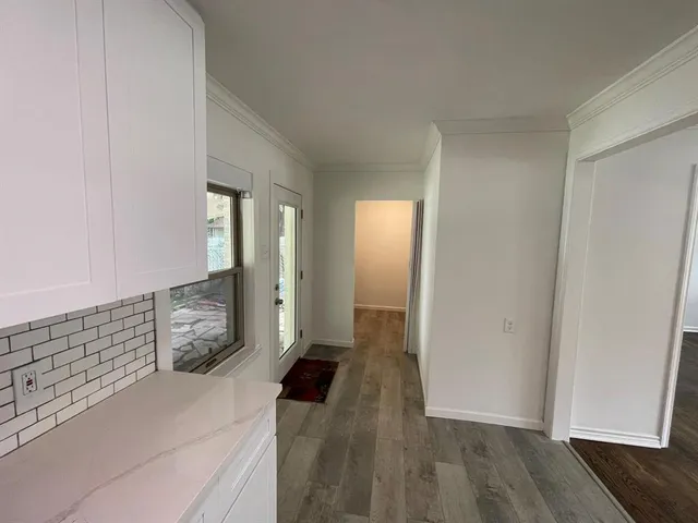 a view of hallway with wooden floor